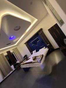 a bedroom with a bed with a blue light on it at gulmarg peak view resort in Gulmarg