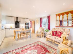 a living room with a couch and a table at Paddock Barn in North Nibley