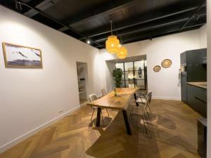 a dining room with a wooden table and chairs at luxe stadsappartement Workum in Workum