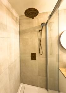 a shower with a glass door in a bathroom at luxe stadsappartement Workum in Workum +12 photos