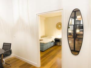 a mirror in a room with a bed and a bedroom at luxe stadsappartement Workum in Workum