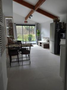 a kitchen and dining room with a table and chairs at La maison d'Amatxi in Itxassou