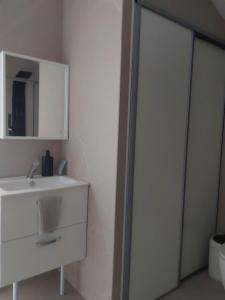 a bathroom with a white sink and a mirror at La maison d'Amatxi in Itxassou +13 photos