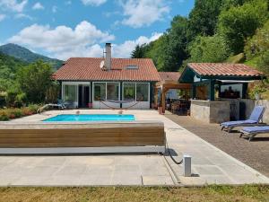 a house with a swimming pool in front of a house at La maison d'Amatxi in Itxassou