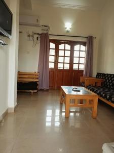 a living room with a couch and a coffee table at Kukus nest blue in Jāmb +2 photos