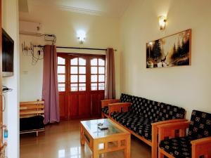 a living room with a couch and a table at Kukus nest blue in Jāmb
