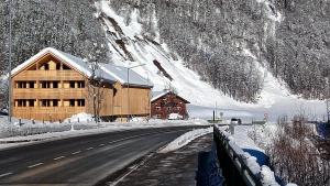 a building on the side of a snow covered road at Apartment Kanisfluh in Mellau