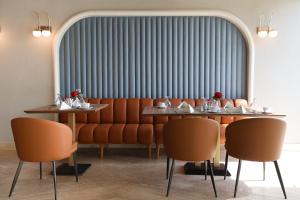 a dining room with two tables and orange chairs at Occidental Cairo Grand Museum in Cairo +23 photos