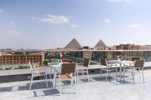 a group of tables and chairs on the roof of a building at Occidental Cairo Grand Museum in Cairo