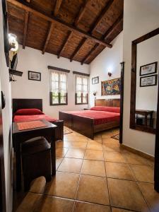 a bedroom with two beds and a table in it at Guva Mangalem Boutique Hotel & Restaurant -Berat Old Town View in Berat
