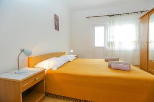 a bedroom with a bed and a desk and a window at Apartmani Sime in Savar