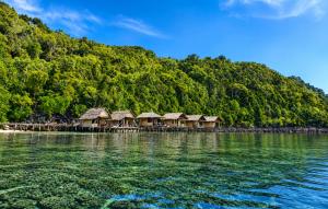a group of huts on a island in the water at Gloria Dive Homestay in Keruo +29 photos