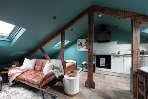 a living room with a couch and a kitchen at Royal Six Apartments in Harrogate