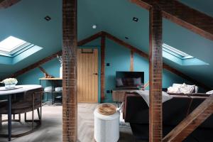 a room with blue ceilings and a room with a table at Royal Six Apartments in Harrogate