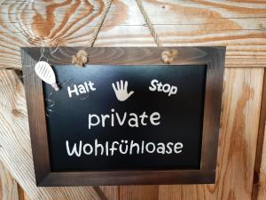 a chalkboard sign on a wall with the words hate stop private workforce at Ferienhaus Bayerlipp in Scheßlitz