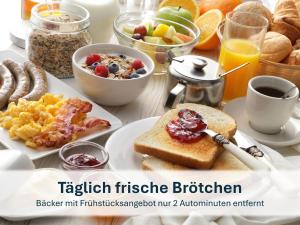 a breakfast table with toast and fruits and breakfast foods at Dresden, Ferienhaus Strietzel in Dresden