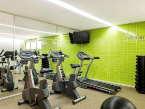 a gym with several exercise bikes and a tv at Novotel Suva Lami Bay in Suva