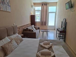 a living room with a couch and a table at Studio Lazaridi in Skala Rachoniou