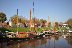a group of boats are docked in the water at Nr 96 - Ferienhaus Uferstraße in Carolinensiel