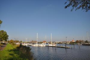 a group of boats docked in a marina at Nr 96 - Ferienhaus Uferstraße in Carolinensiel
