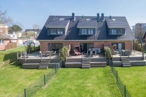 a large house with a lawn in front of it at Fennenblick in List