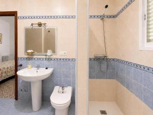 a bathroom with a sink and a toilet and a shower at Hostal Muriel in Aljaraque