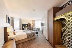 a hotel room with a bed and a desk at Astra Vevey Hotel & Restaurant in Vevey +76 photos