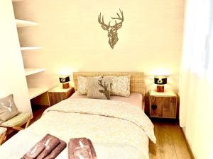 a bedroom with a bed with a deer head on the wall at Le Petit Observatoire in Chardonne