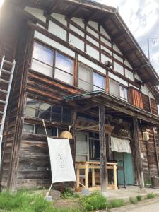 a building with a sign in front of it at GuestHouse MIRAI in Tokamachi
