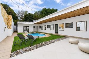 a backyard with a swimming pool and a house at Hunni Hotel Melrose Edge in Johannesburg +47 photos