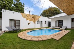a swimming pool in the yard of a house at Hunni Hotel Melrose Edge in Johannesburg