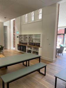 a room with tables and chairs in a building at Ashbourne Gateway Lodge in Ashbourne