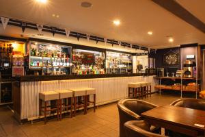a bar with tables and chairs in a restaurant at a&o Edinburgh City in Edinburgh +24 photos