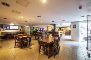 a restaurant with wooden tables and chairs in a room at a&o Edinburgh City in Edinburgh