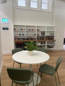 a white table and chairs in a room at Ashbourne Gateway Lodge in Ashbourne