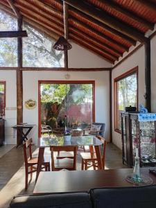 a dining room with a table and chairs at Chalé da Estação in Carrancas