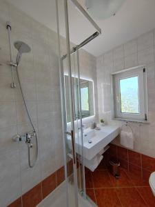 a bathroom with a sink and a shower at Apartments Damir in Sveti Ivan Dobrinjski +40 photos
