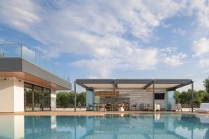 a rendering of a house with a swimming pool at Aesthea 5-star Villa, 2Pools, Gym, Cinema, Sauna, By ThinkVilla in Prínos