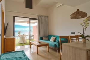 a living room with a blue couch and a table at Serenity Amadores in Puerto Rico de Gran Canaria