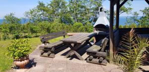a wooden picnic table with a light on top of it at Residenz Seeblick Whg 4, mit Gartenzugang in Ostseebad Sellin