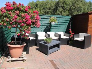 a patio with a bunch of chairs and flowers at Ferienhaus Smerzinski in Bergen auf Rügen