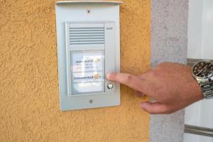 a person pressing a lightswitch on a wall at Hotel Sonnenklahr mit Pool in Göhren +41 photos
