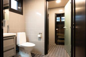 a bathroom with a toilet and a sink at Sea Haven Villa in Trutberget