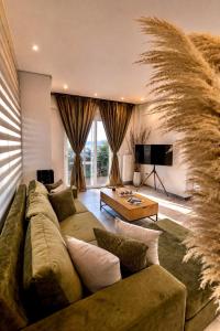 a living room with a couch and a table at Allure villa in Porto Rafti
