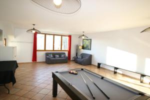 a living room with a pool table in it at Le Clos Auvergnat in Tauves