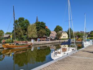 two boats are docked at a dock in the water at FW Im grünen Weg in Wustrow