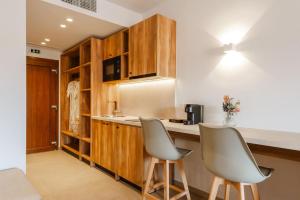 a kitchen with two chairs and a counter top at EMERALD Luxury Living in Syvota