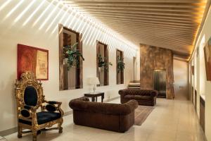 a hallway with couches and chairs in a building at Borgo Santa Giulia in Corte Franca +60 photos
