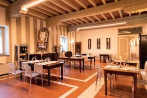 a large room with tables and chairs in it at Borgo Santa Giulia in Corte Franca