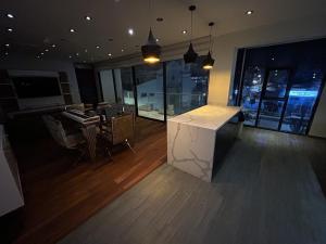 a large room with a counter in a room with a desk at Luxury apartment with park views in Huancavelica